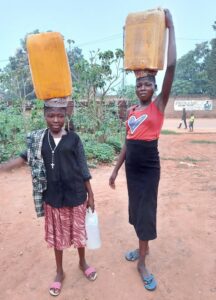 Bringing in water from a nearby stream.